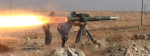 In this picture released on June 26, 2015, by a website of Islamic State militants, Islamic State militants fire an anti-tank missile in Hassakeh, northeast Syria. Andreas Krieg, a professor at King's College London who embedded with Iraqi Kurdish fighters in the fall of 2014, says IS local commanders are given leeway to operate as they see fit. They "have overall orders on strategy and are expected to come up with the most efficient ways of adapting it," he said. (Militant website via AP)